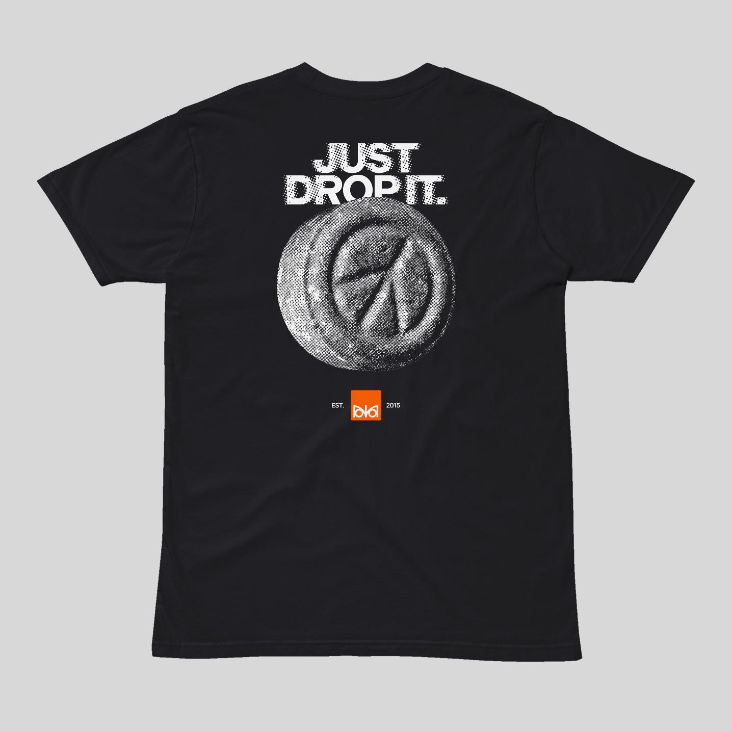 Black t-shirt with 'Just Drop It' text and pill graphic on a gray background