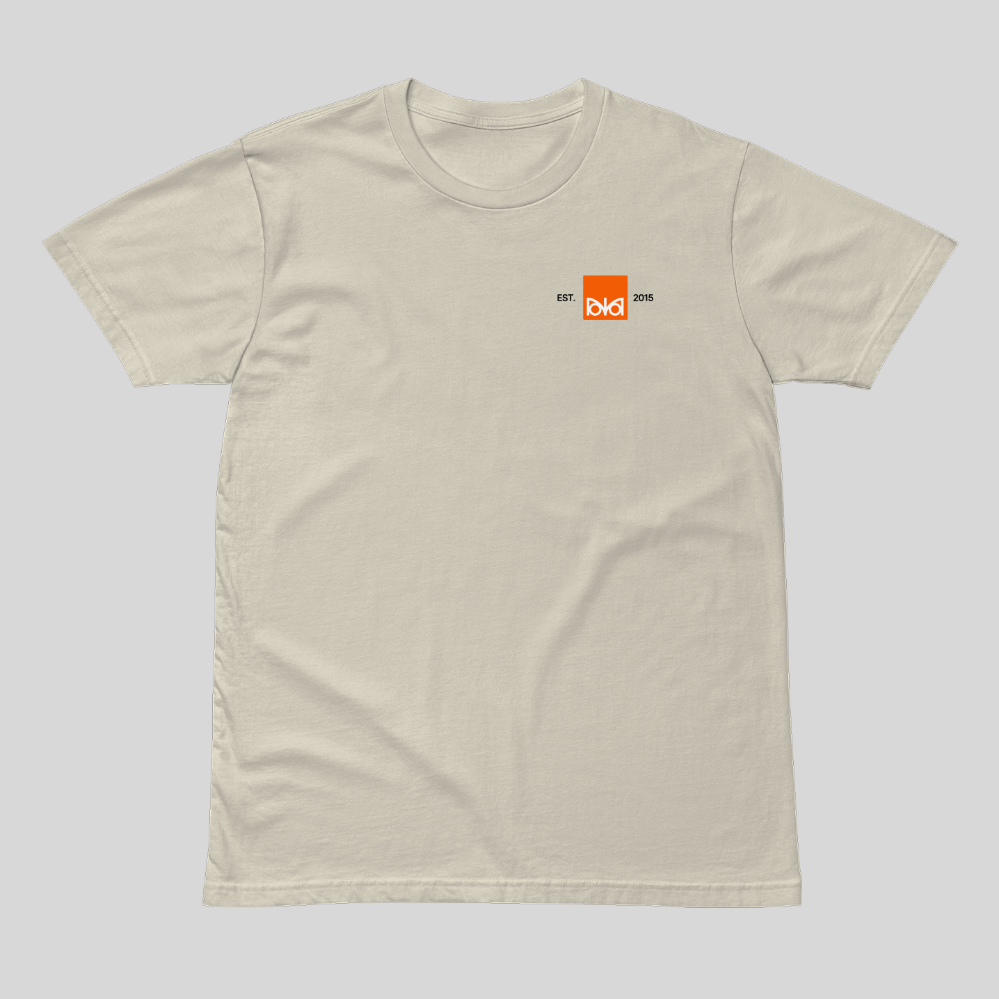 Beige t-shirt with a small orange logo on a light gray background